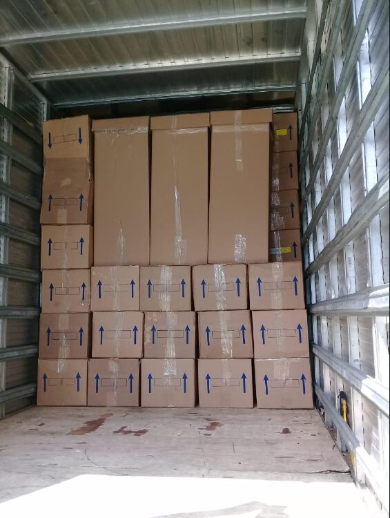 Baú do caminhão carregado e organizado com caixas de mudança